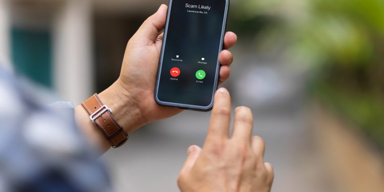 Over shoulder close up view of a man using smartphone include clipping path screen in blurred background